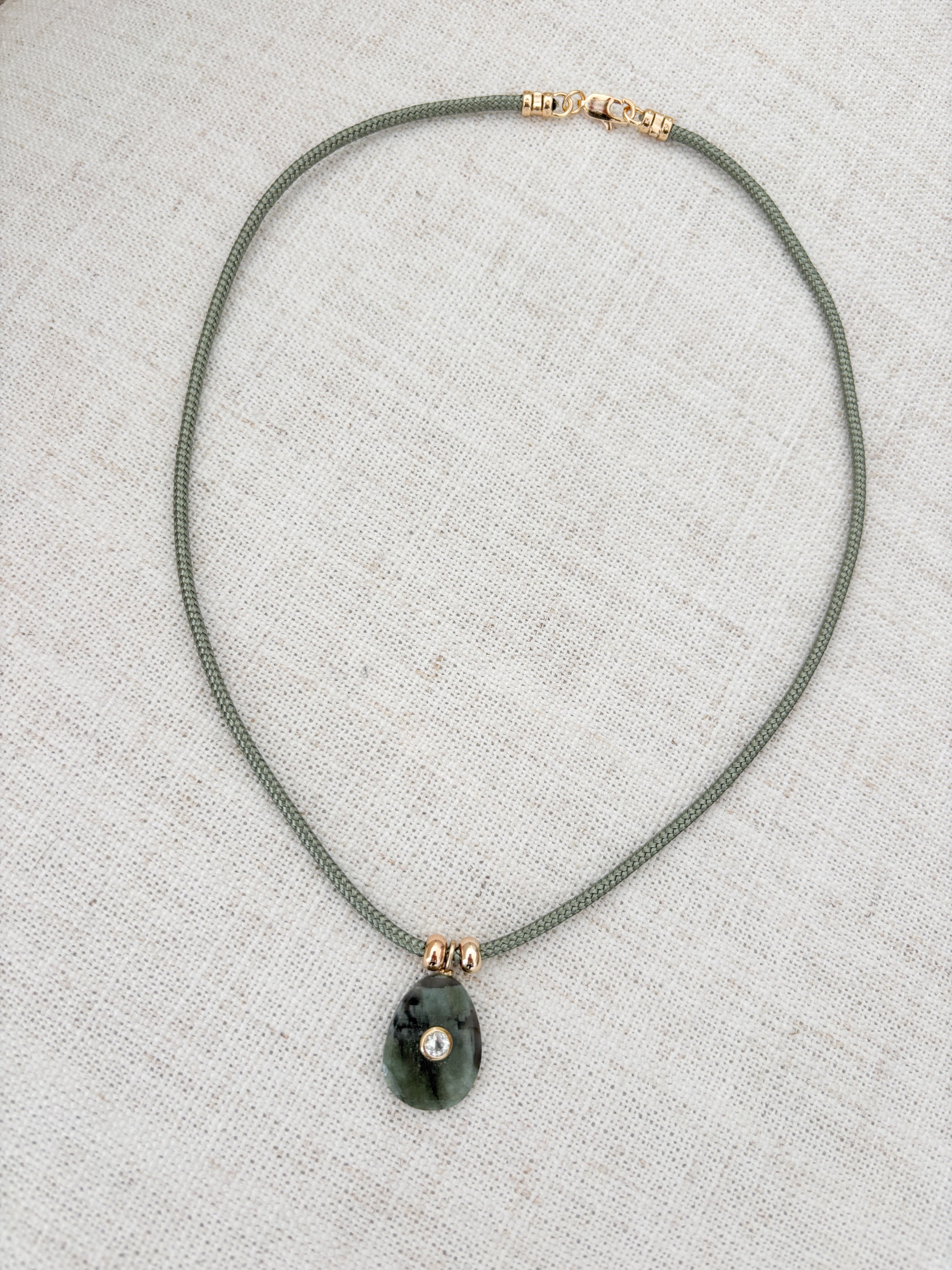 Raw emerald on Cord