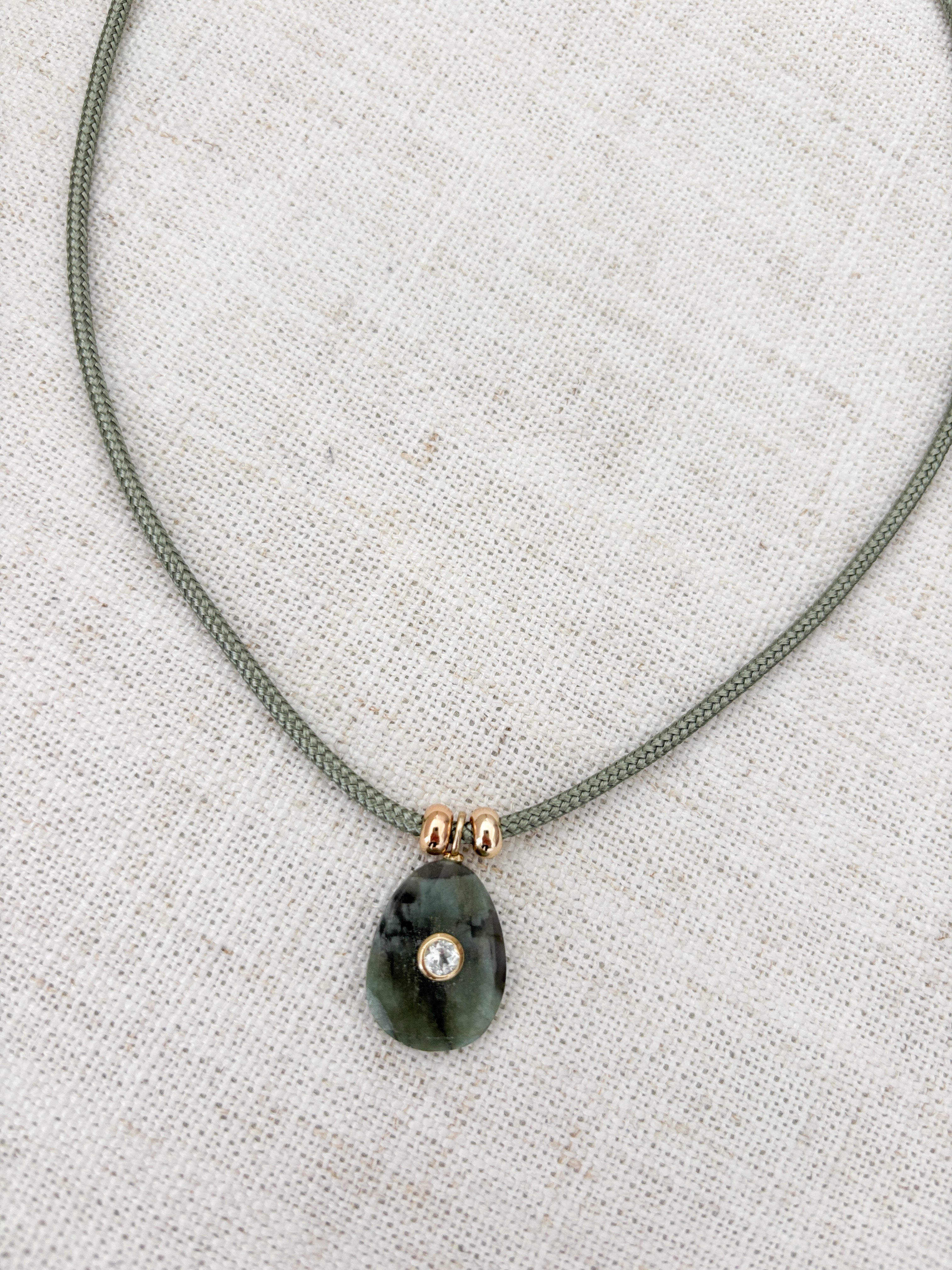 Raw emerald on Cord